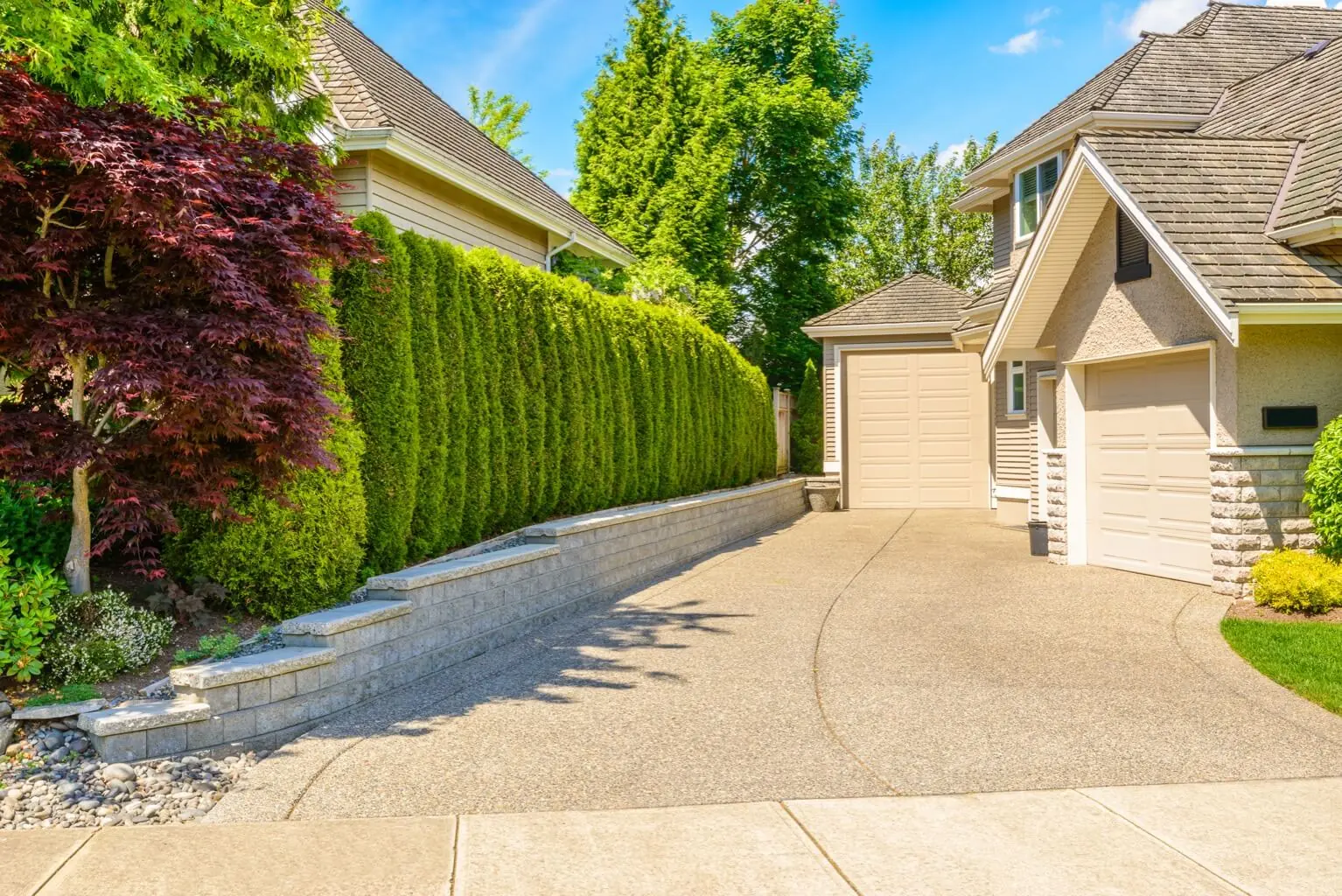 Landscaped residential concrete driveway